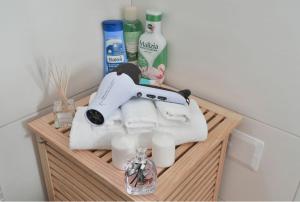 a shelf with towels and other bathroom items on it at Lux Apartman Daria in Zlatibor +11 photos