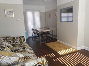 a living room with a couch and a table at Liverpool City House in Liverpool