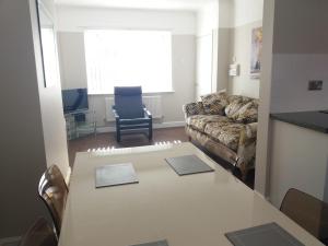 a living room with a table and a couch at Liverpool City House in Liverpool