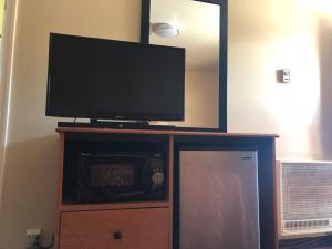 a flat screen tv sitting on top of a entertainment center at Evergreen Lodge in Mount Shasta