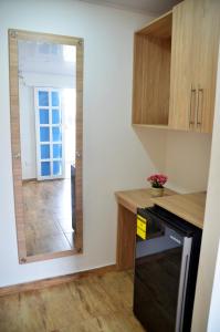 a kitchen with a mirror next to a hallway at Summer Breeze in San Andrés