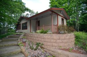a small house with a brick wall in front of it at Sunset on the Bay Condo in Hayward