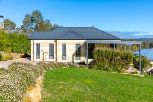 a house with a green lawn in front of it at Alfies on Albert Daylesford in Daylesford