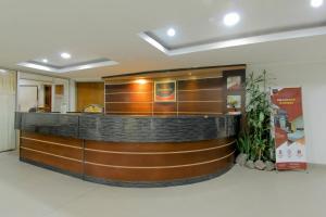 a lobby with a reception counter in a building at University Hotel in Kalasan