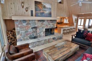 a living room with a stone fireplace in a house at Serenity On Lake Owen Condo in Cable +47 photos