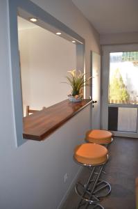 a room with two stools and a mirror on the wall at Jana's Fewo in Lübeck