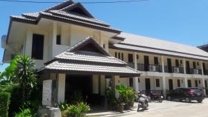 a building with a car parked in front of it at Papillon Residence in Choeng Mon Beach