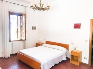 a white bedroom with a bed and a window at Agriturismo Testalepre in Greve in Chianti +62 photos