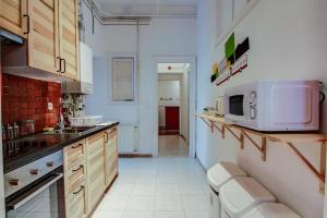 a kitchen with a sink and a microwave at Pal's Mini Hostel in Budapest