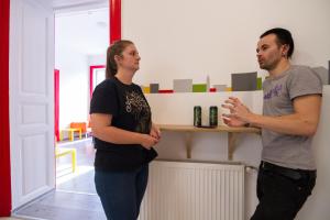a man and a woman standing in a room at Pal's Mini Hostel in Budapest