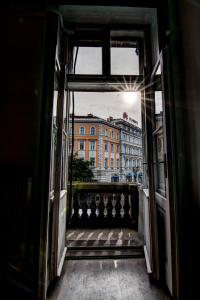 a view of a building from an open window at Pal's Mini Hostel in Budapest
