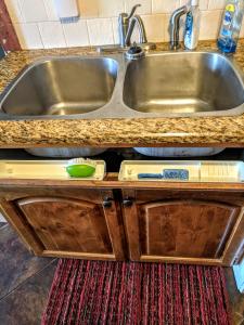 a kitchen counter with a sink and a rug at Vintage Cozy Family Home near National Parks in Saint Anthony