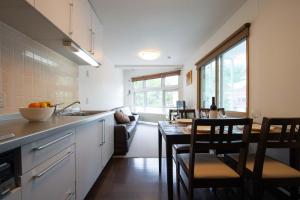 a kitchen and dining room with a table and chairs at Yukon in Kutchan