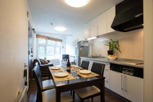 a kitchen with a table and chairs in a room at Yukon in Kutchan +32 photos