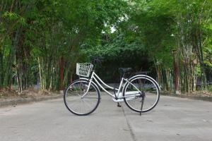 a bike with a basket parked on a street at Bamboori Boutique Resort in Chiang Mai