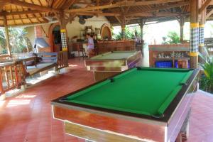 a pool table in the middle of a room at Hotel Uyah Amed Spa Resort in Amed