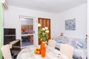 a living room with a table with a vase of flowers at Marie in Split