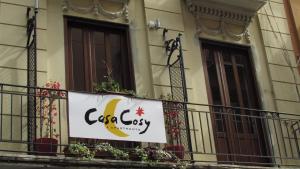 a banner on a balcony of a building with flowers at Casa Cosy in Valencia