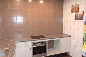a kitchen with a stove and a counter top at Nakvynė Miroslave in Alytus