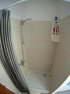 a shower with a shower curtain in a bathroom at Salona suite in Solin