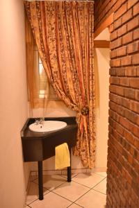 a bathroom with a sink and a window at The Cedars Bed and Breakfast in Centurion