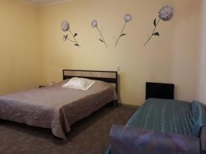 a bedroom with two beds and flowers on the wall at Смарт-апартаменти " Lutskyj zamok" in Lutsk
