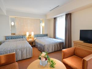 Postel nebo postele na pokoji v ubytování Hotel Crown Palais Kobe