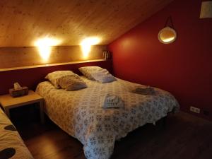 a bedroom with a bed with two pillows on it at Chambre Chaleureuse chez l'habitant in Bourg-en-Bresse