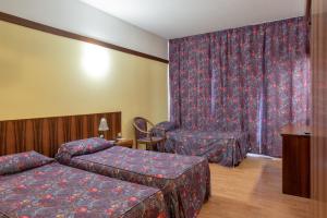 A bed or beds in a room at Park Hotel Oasi