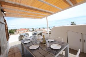 a dining table on the balcony of a house at Casa Acacia Mar in Cambrils