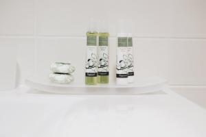 a shelf with four bottles of hair products on it at Cascina Speranza Hotel in Riva presso Chieri
