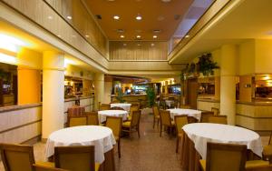 a dining room with white tables and chairs at Hotel San Antonio in Albacete