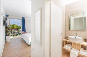 a white bathroom with a sink and a mirror at Boutique Flamingo B&B in Mlini +39 photos