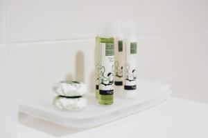 a shelf with two bottles of essential oils on it at Cascina Speranza Hotel in Riva presso Chieri