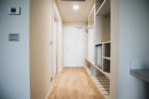 a hallway with white walls and wooden floors at Cascina Speranza Hotel in Riva presso Chieri