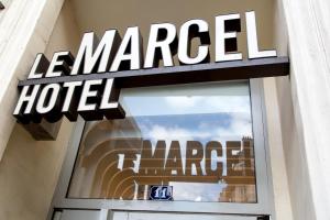 a store sign for a le marbella hotel at Hôtel Le Marcel Paris Gare de l'Est in Paris