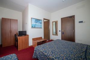 En eller flere senge i et værelse på Hotel Italia & Lombardi