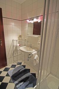 a bathroom with a sink and a mirror at Appartements am Kurpark in Bad Mitterndorf