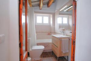 a bathroom with a toilet and a sink and a tub at The Painter's Home in Vilassar de Mar +26 photos