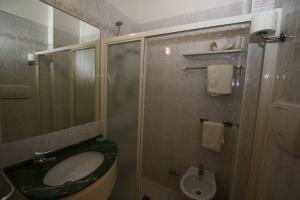 a bathroom with a toilet and a sink and a shower at Hotel Marco Polo in Bellaria-Igea Marina
