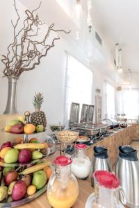 
a table topped with lots of fruits and vegetables at Harmony Boutique Hotel in Mýkonos City
