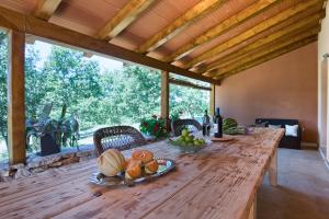 a long wooden table with fruit on top of it at Beautiful villa Palera with private pool near Pula in Ližnjan