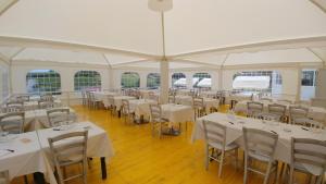 a room with tables and chairs in a white tent at Affittacamere Stranamore in Frascati