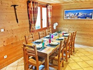a dining room with a wooden table and chairs at Chalet in Champagny en Vanoise with Vanoise summits in Le Villard
