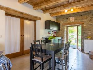 a kitchen and dining room with a table and chairs at Pretty Farmhouse with pool in Sestino