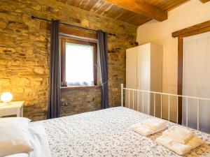 a bedroom with a bed and a window at Pretty Farmhouse with pool in Sestino +32 photos