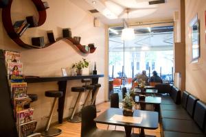 a bar with tables and chairs in a restaurant at Arethusa Hotel Athens in Athens