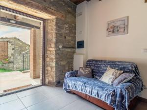 a living room with a couch and a sliding glass door at Pretty Farmhouse with pool in Sestino