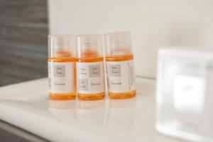 three bottles of essential oils sitting on a table at Aelia Studios in Koukounaries