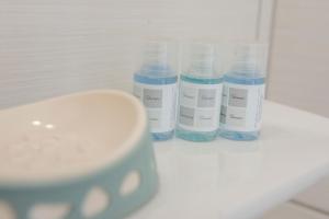 a row of blue and white bottles on a counter at Aelia Studios in Koukounaries